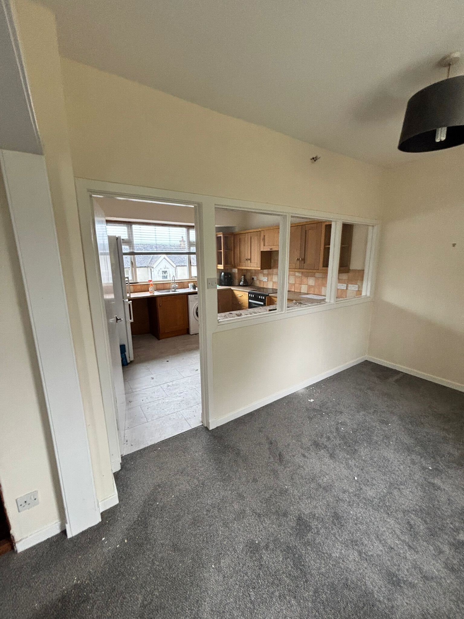 Scottish heritage renovation - existing living room looking through to kitchen showing internal layout to be reconfigured under listed building consent